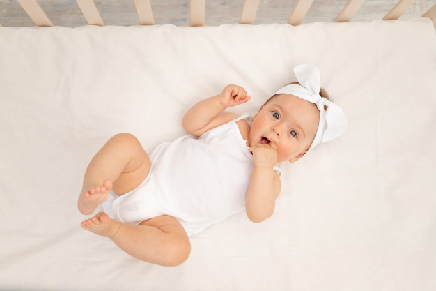 baby-girl-lying-crib-nursery-267293-18